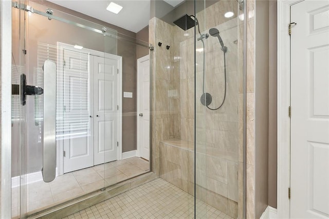 bathroom with a stall shower and tile patterned floors