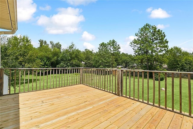 wooden terrace with a lawn