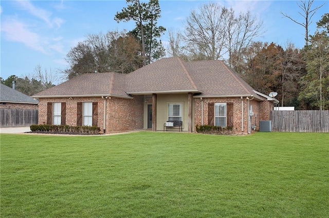 ranch-style house with central AC unit and a front lawn