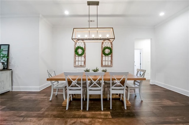 dining area with ornamental molding and dark hardwood / wood-style flooring