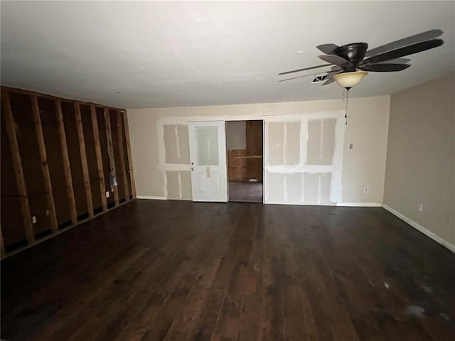 empty room featuring ceiling fan and dark hardwood / wood-style flooring