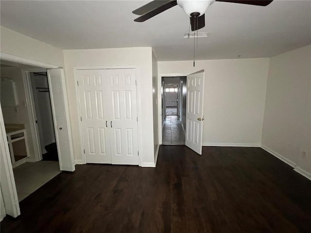 unfurnished bedroom featuring dark wood-type flooring and ceiling fan