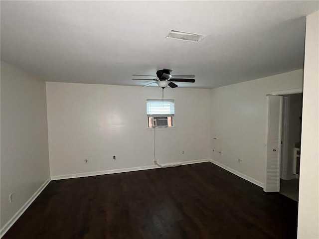 empty room with dark hardwood / wood-style flooring, cooling unit, and ceiling fan