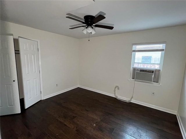 empty room with cooling unit, ceiling fan, and dark hardwood / wood-style flooring