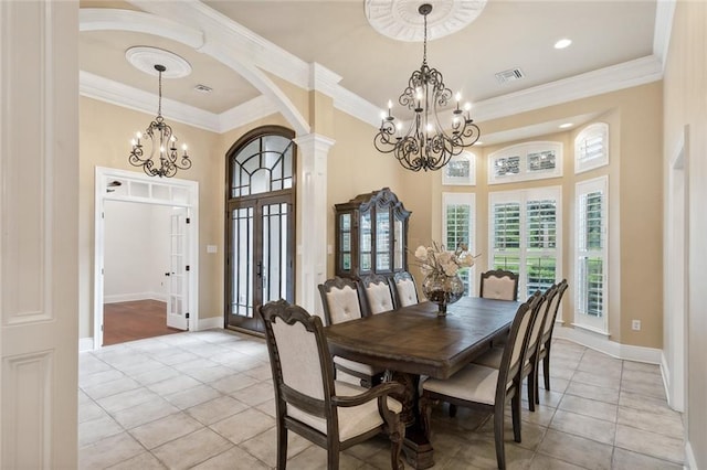 tiled dining room featuring ornamental molding, a towering ceiling, a notable chandelier, and french doors