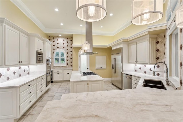 kitchen with a kitchen island, appliances with stainless steel finishes, pendant lighting, sink, and ornamental molding