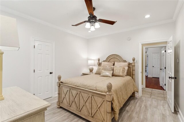 bedroom with ornamental molding, ceiling fan, and light wood-type flooring