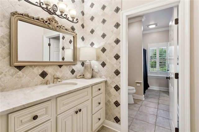 bathroom featuring tile patterned flooring, vanity, ornamental molding, and toilet