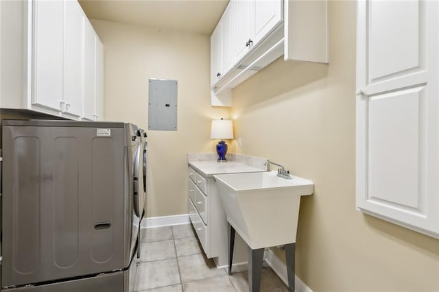 laundry room featuring cabinets, light tile patterned floors, electric panel, and washer and clothes dryer