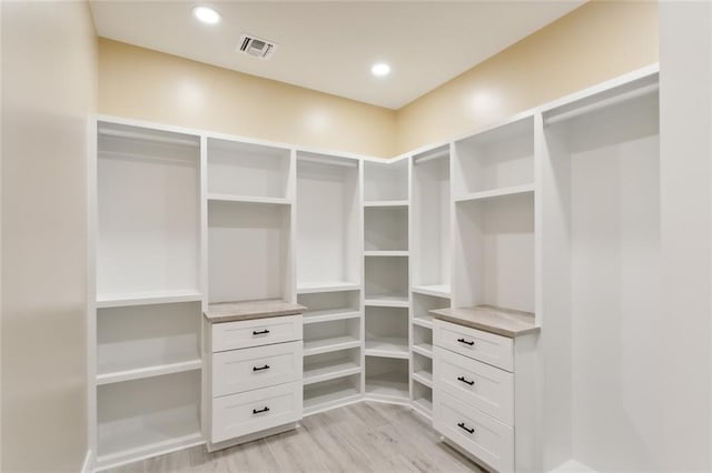 spacious closet with light hardwood / wood-style floors