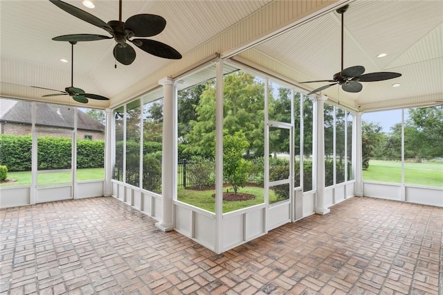 unfurnished sunroom featuring vaulted ceiling and ceiling fan