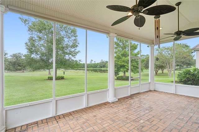 unfurnished sunroom with ceiling fan