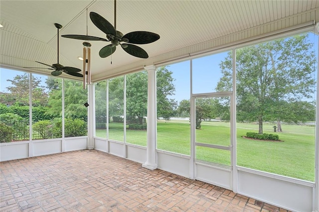 unfurnished sunroom featuring ceiling fan