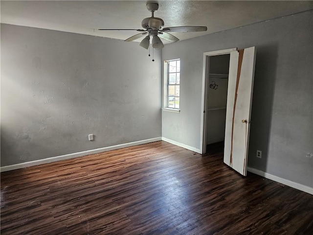 unfurnished bedroom with dark wood-type flooring and ceiling fan