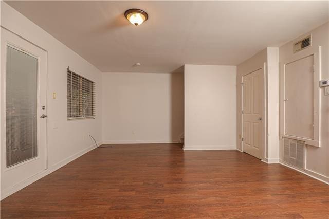 spare room with dark hardwood / wood-style flooring