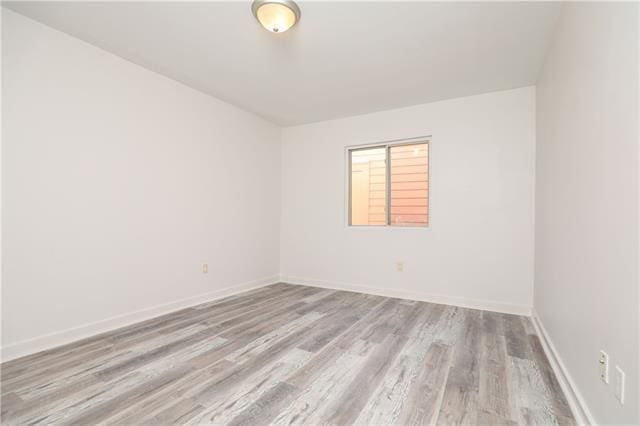 empty room with light hardwood / wood-style flooring