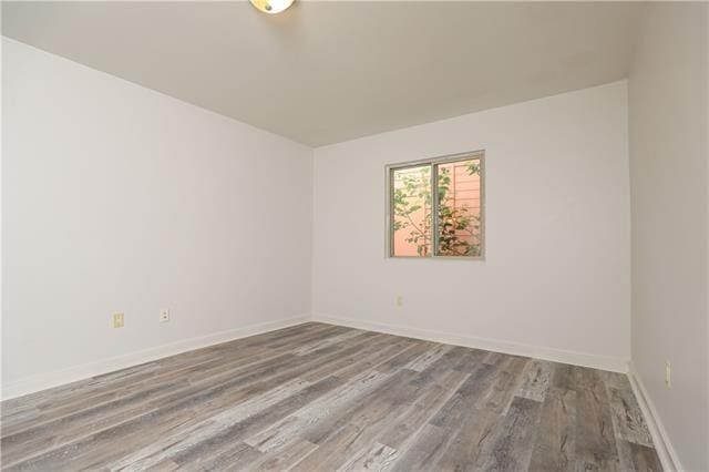 spare room with hardwood / wood-style flooring