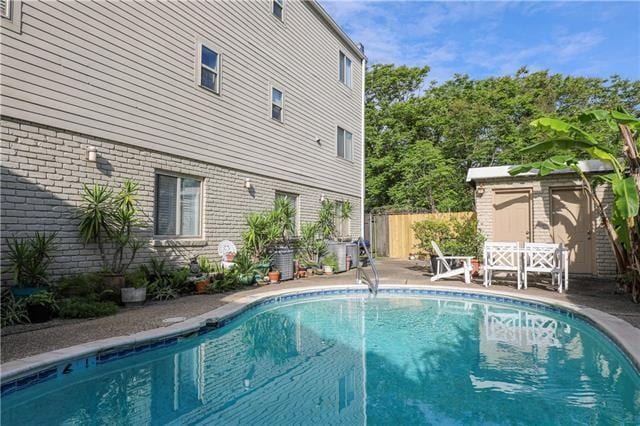 view of pool with a storage shed