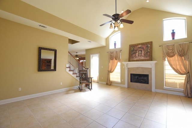 unfurnished living room with light tile patterned flooring, ceiling fan, and high vaulted ceiling