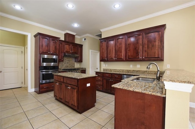 kitchen featuring sink, light stone counters, ornamental molding, appliances with stainless steel finishes, and kitchen peninsula