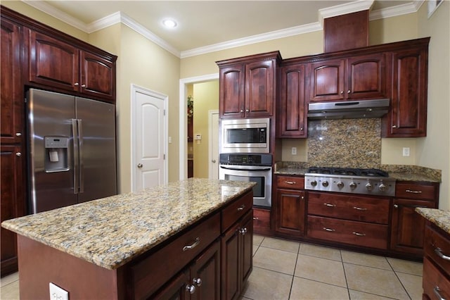 kitchen with crown molding, appliances with stainless steel finishes, a center island, light stone counters, and tasteful backsplash