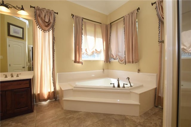 bathroom featuring vanity and a bath