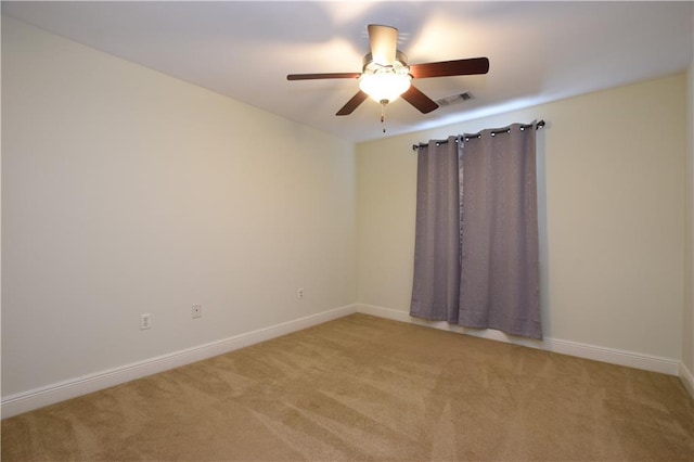 carpeted spare room with ceiling fan