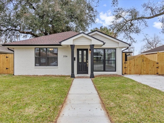 bungalow-style home featuring a front lawn