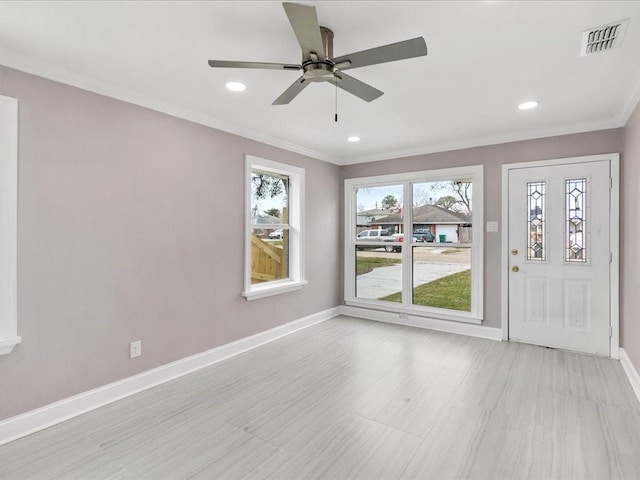 interior space with crown molding and ceiling fan