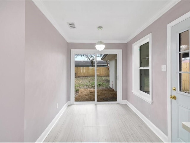 unfurnished dining area with crown molding and light wood-type flooring