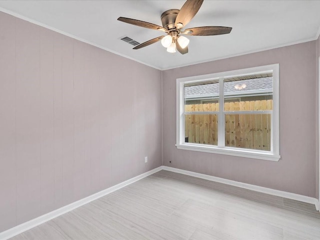 empty room with crown molding, light hardwood / wood-style flooring, and ceiling fan