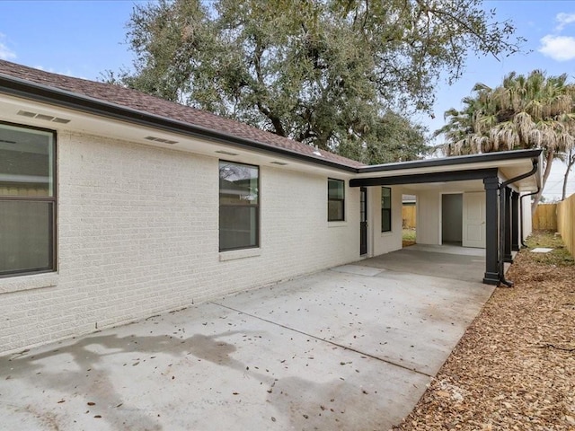 back of house featuring a patio and a carport