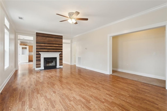 unfurnished living room featuring ornamental molding, ceiling fan, and light hardwood / wood-style flooring