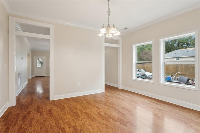 unfurnished dining area featuring crown molding, an inviting chandelier, and hardwood / wood-style flooring