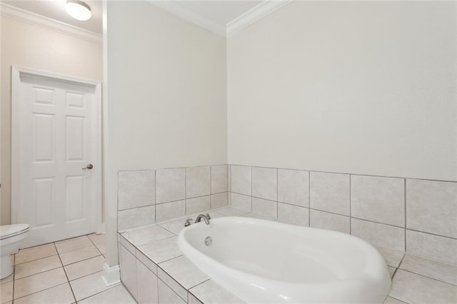 bathroom featuring ornamental molding, tiled bath, tile patterned floors, and toilet