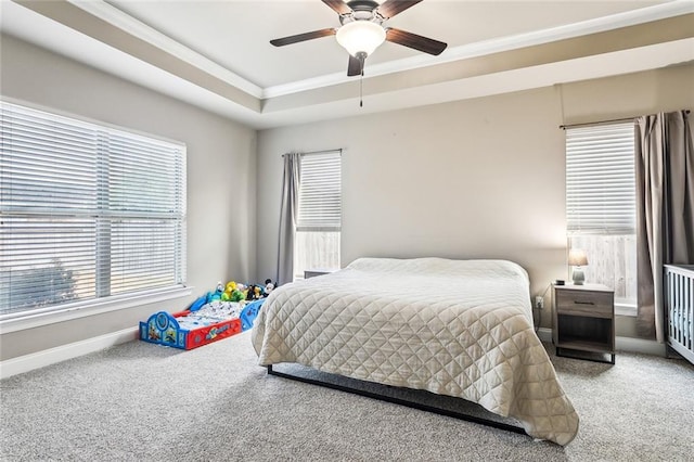 bedroom with ceiling fan, ornamental molding, a raised ceiling, and carpet