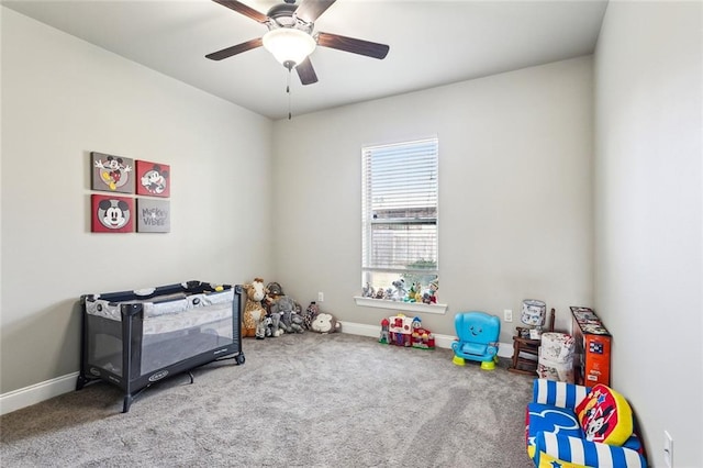 playroom featuring ceiling fan and carpet