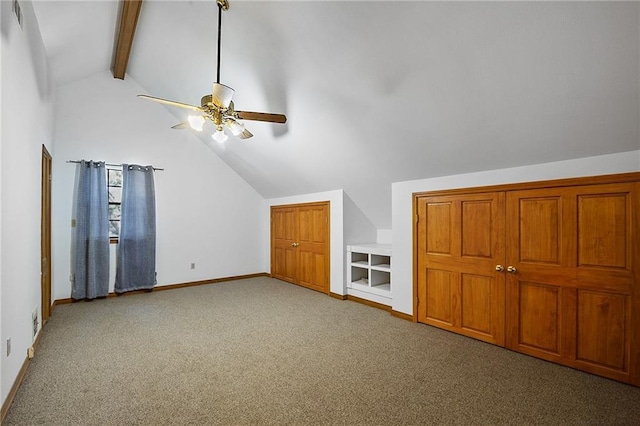 additional living space with lofted ceiling with beams, carpet, and ceiling fan