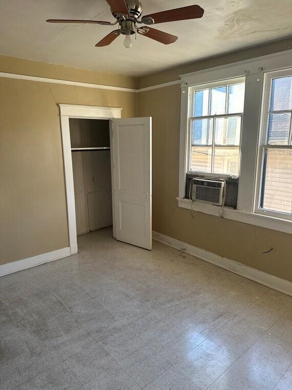3526 Louisiana Ave Parkway, New Orleans, LA 70125 - unfurnished bedroom with multiple windows, cooling unit, ceiling fan, and a closet