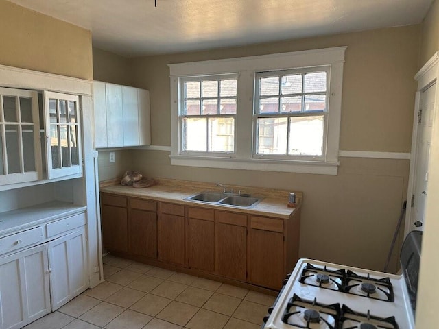 3526 Louisiana Ave Parkway, New Orleans, LA 70125 - kitchen with sink, light tile patterned floors, and white gas stove