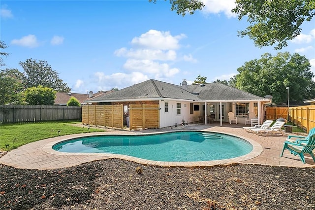 view of swimming pool with a yard and a patio area