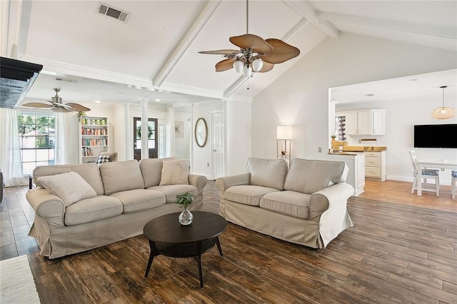 living room with hardwood / wood-style flooring, plenty of natural light, and beamed ceiling