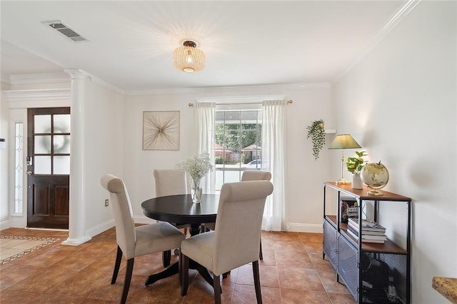 tiled dining space featuring decorative columns and ornamental molding