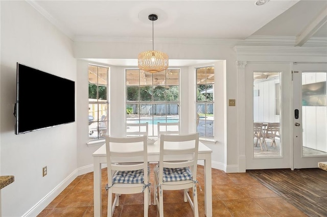 dining area with ornamental molding and tile patterned flooring