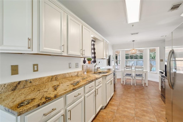 kitchen featuring white cabinetry, sink, and pendant lighting