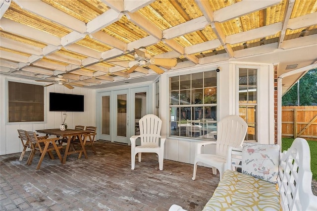 sunroom featuring ceiling fan