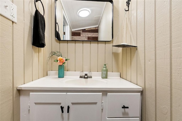 bathroom with vaulted ceiling and vanity