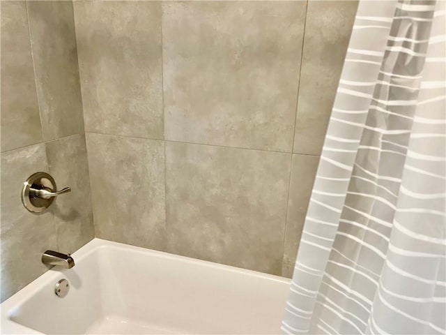 bathroom with shower / bath combination with curtain