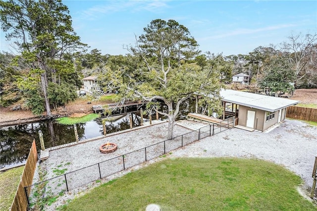 view of yard with a fire pit and a water view