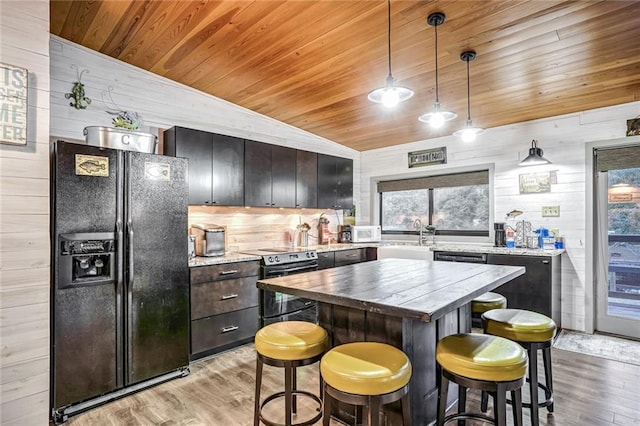 kitchen with light wood-type flooring, black fridge with ice dispenser, wood walls, electric stove, and wooden ceiling
